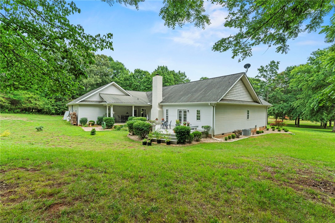 160 Sentell Road Williamston, SC 29697 - Photo 31 of 45 A spacious backyard with mature trees offers a serene natural setting for outdoor enjoyment.