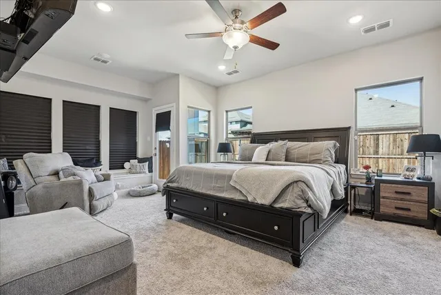 a spacious bedroom with a bed and window