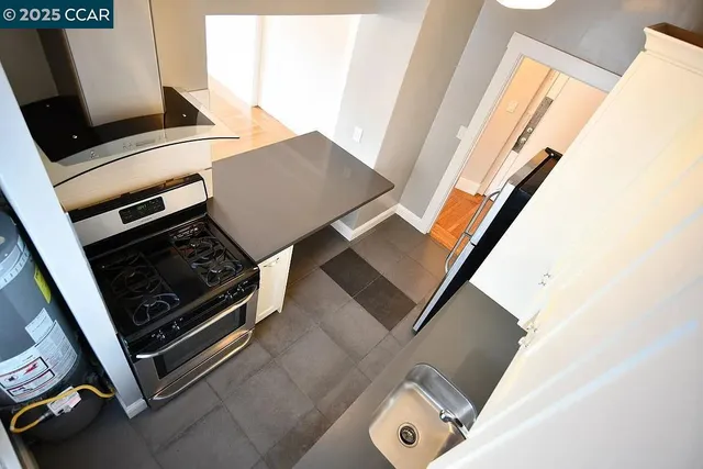 a stove top oven sitting next to a window