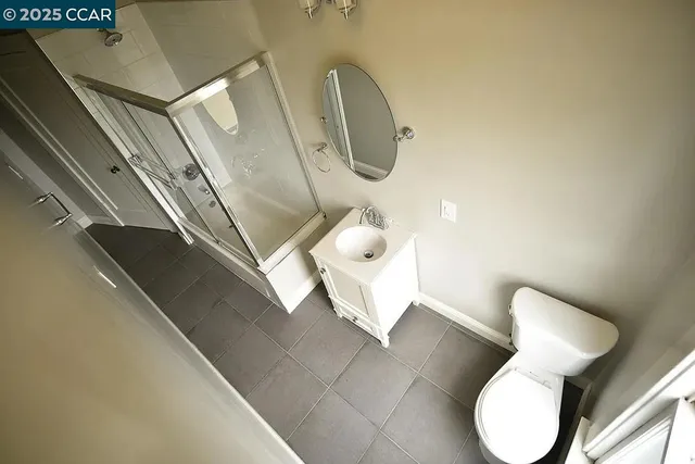 a bathroom with a toilet mirror and sink