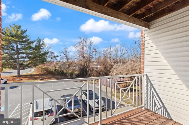a view of a balcony with furniture and wooden floor