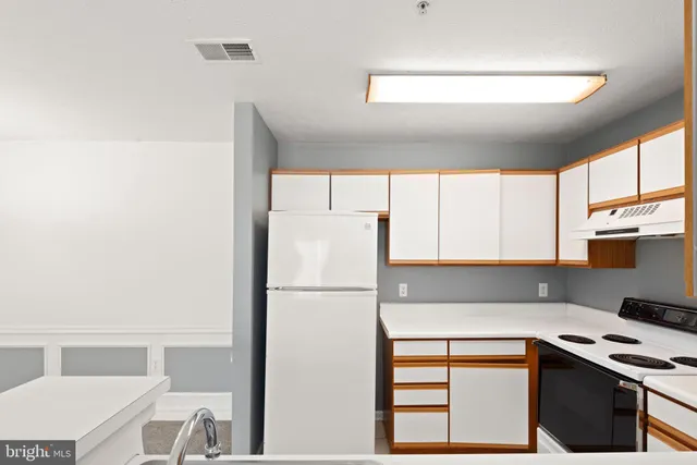 a kitchen with a window a sink and a refrigerator