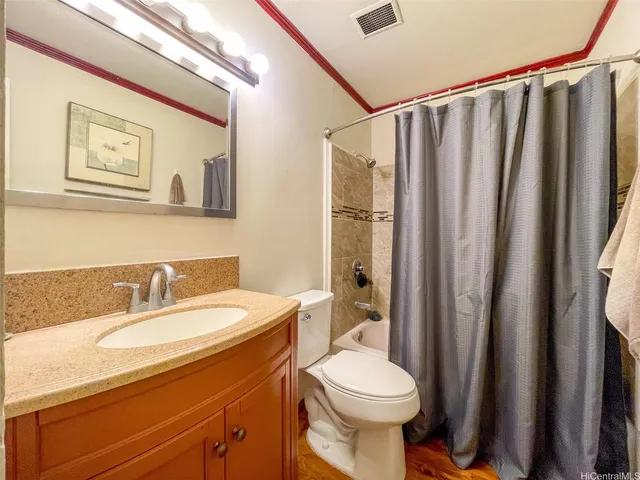 a bathroom with a sink a mirror a toilet and shower