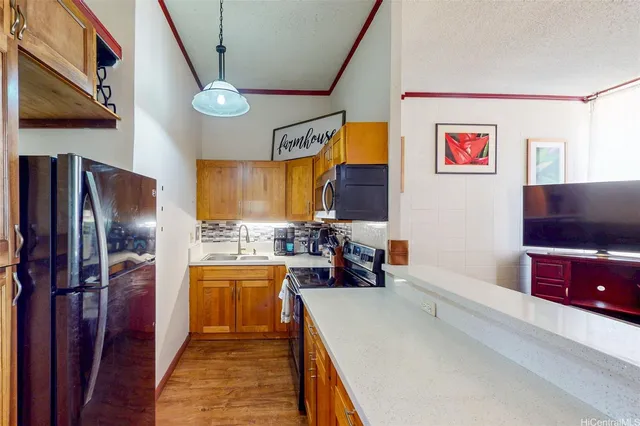 a kitchen with lots of counter top space and stainless steel appliances