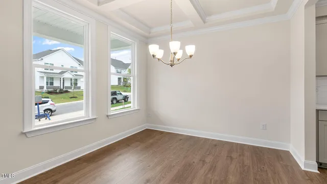 en empty room with wooden floor and window