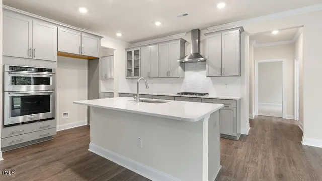 a kitchen with kitchen island a sink stainless steel appliances and cabinets