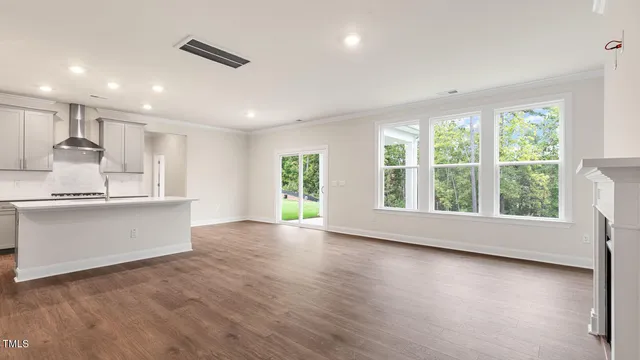 a view of kitchen with wooden floor and electronic appliances