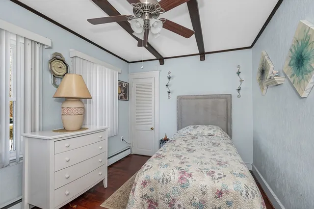 a bedroom with a bed and a mirror on the dresser