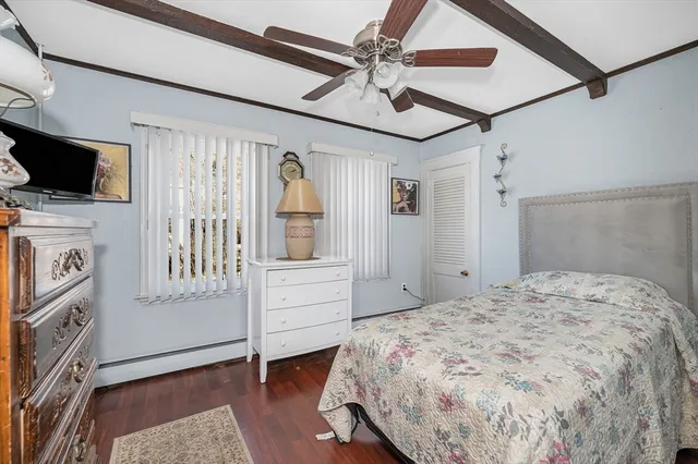 a bedroom with a large bed and a flat screen tv