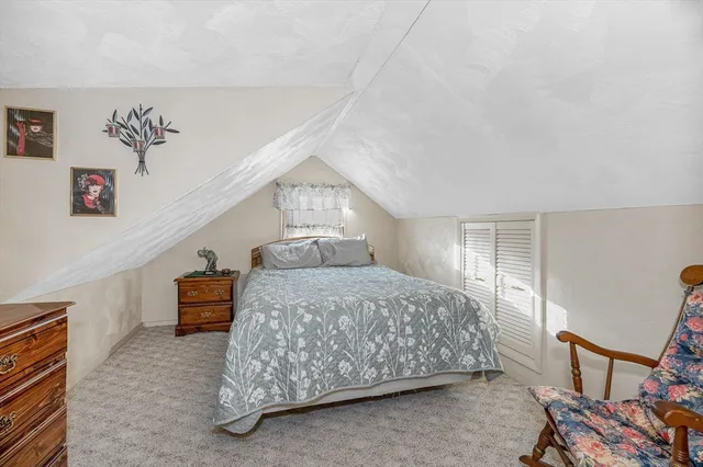 a bedroom with a bed and a dresser in it