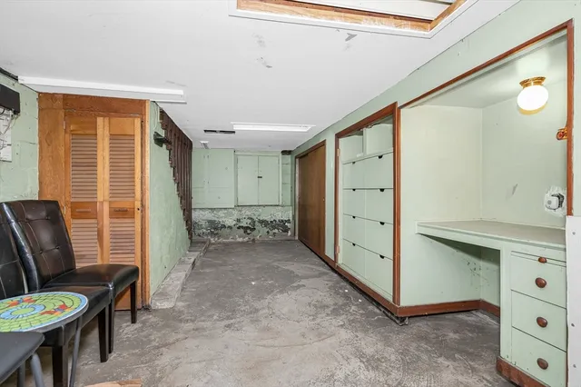 a view of a hallway with furniture and toys