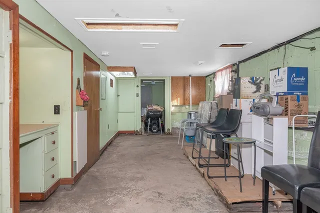 a view of a livingroom with workspace and a window