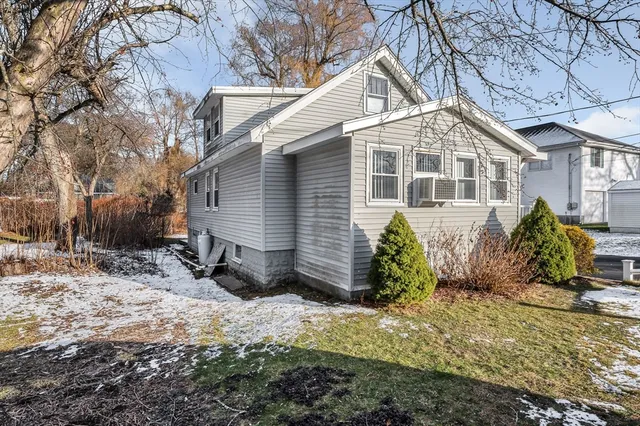 a view of a house with a yard covered in snow