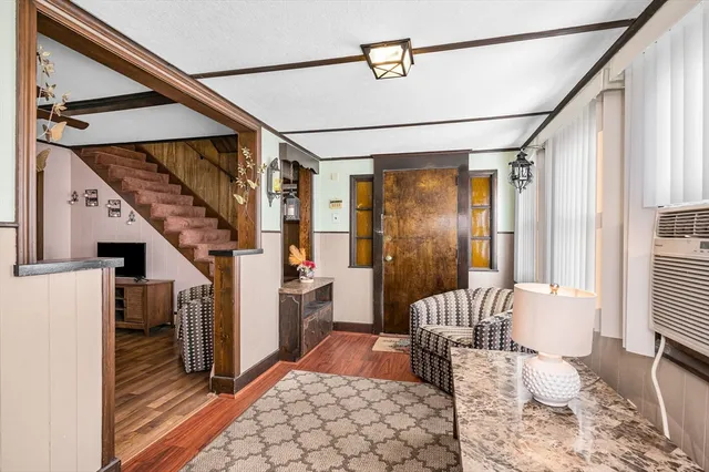 a view of hallway with furniture and a window