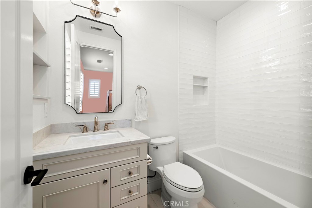 8 Kane Lane Ladera Ranch, CA 92694 - Photo 26 of 49 a bathroom with a toilet a sink a mirror a bathtub and vanity