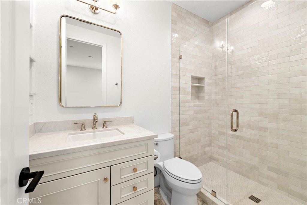 8 Kane Lane Ladera Ranch, CA 92694 - Photo 28 of 49 a bathroom with a toilet sink vanity and mirror