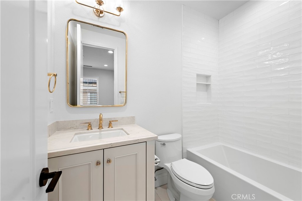 8 Kane Lane Ladera Ranch, CA 92694 - Photo 30 of 49 a bathroom with a toilet a sink a mirror and vanity