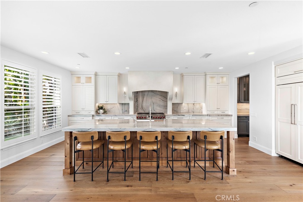 8 Kane Lane Ladera Ranch, CA 92694 - Photo 3 of 49 a large kitchen with a table and chairs in it