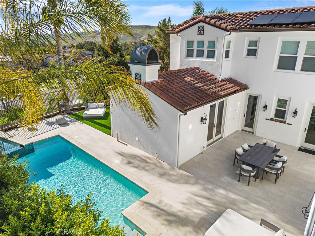 8 Kane Lane Ladera Ranch, CA 92694 - Photo 36 of 49 a view of a white house with a yard table and chairs