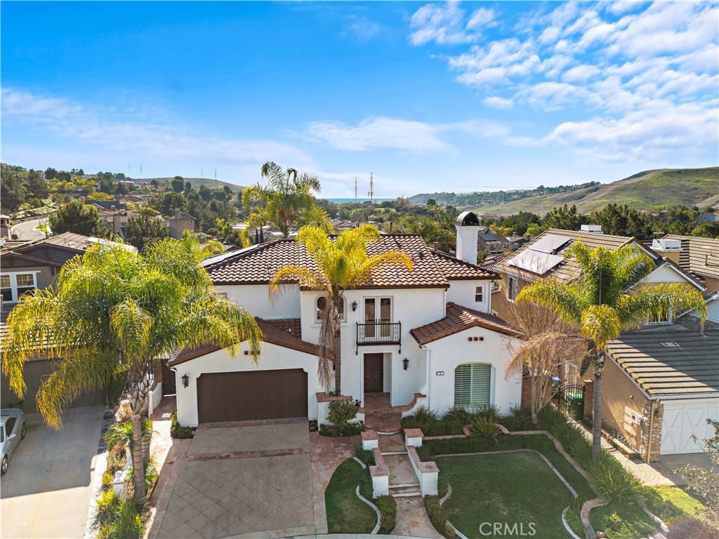 8 Kane Lane Ladera Ranch, CA 92694 - Photo 40 of 49 a view of a white house with a big yard and potted plants