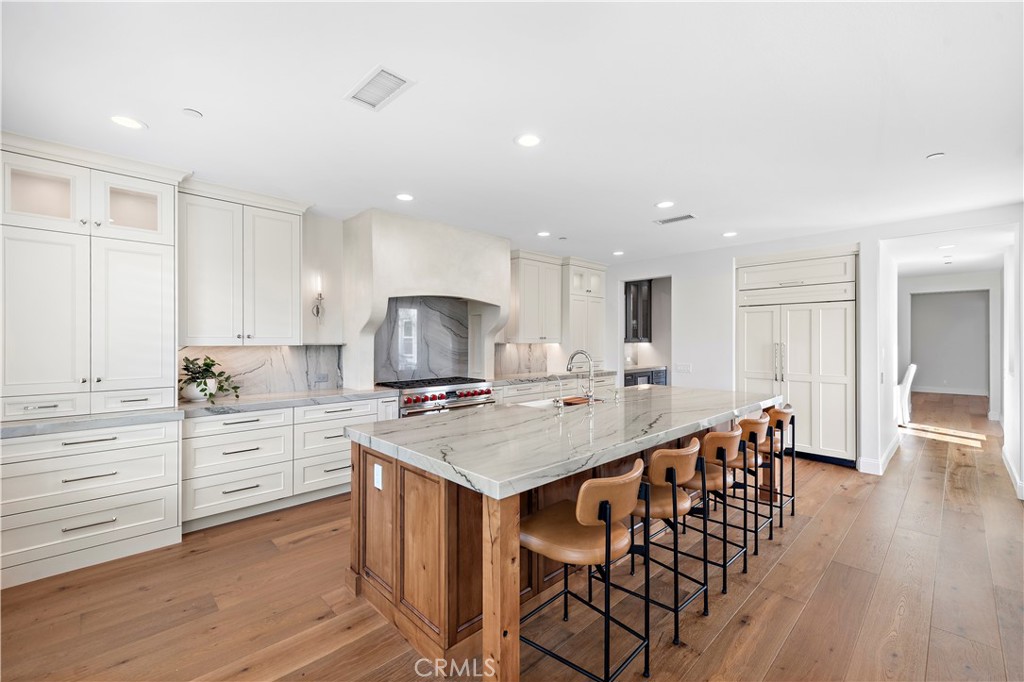 8 Kane Lane Ladera Ranch, CA 92694 - Photo 4 of 49 a large kitchen with a table and chairs