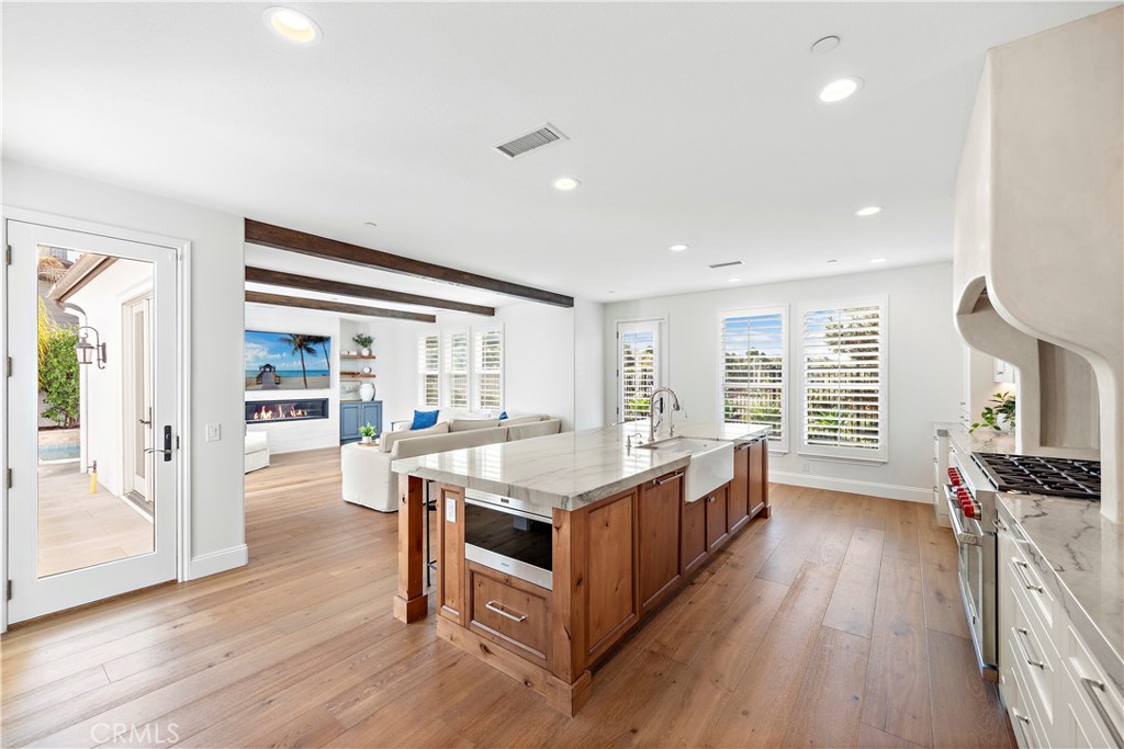 8 Kane Lane Ladera Ranch, CA 92694 - Photo 5 of 49 a open kitchen with stainless steel appliances granite countertop a stove oven and a refrigerator with wooden floor