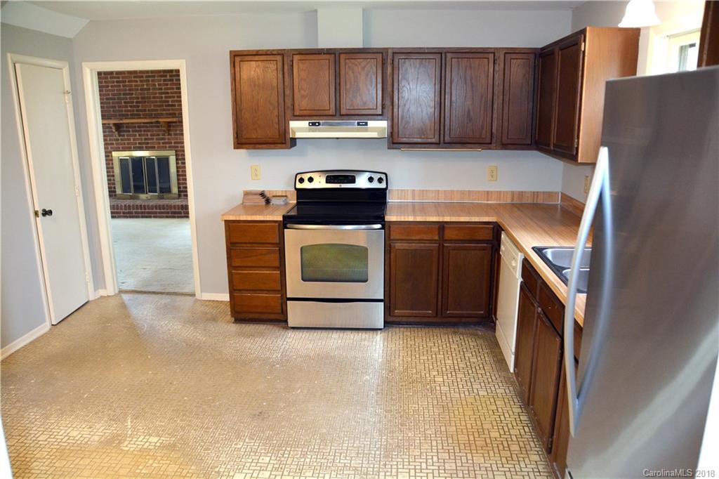 8700 Houston Ridge Road Charlotte, NC 28277 - Photo 11 of 22 a kitchen with a refrigerator sink and cabinets