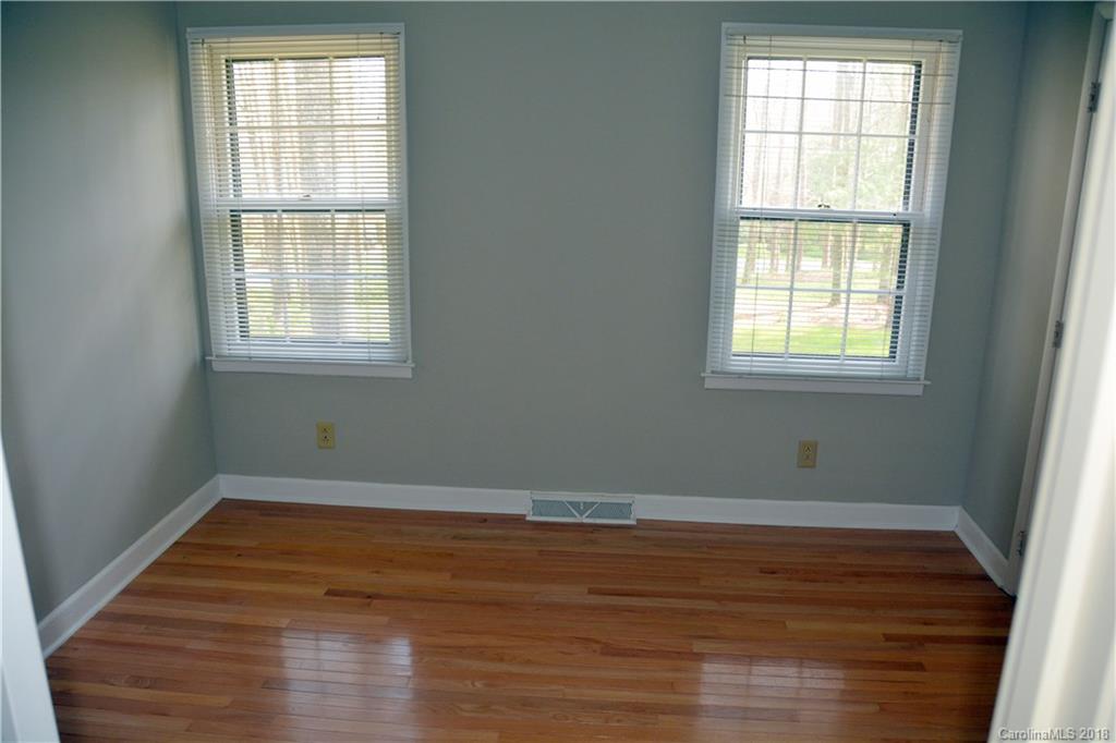 8700 Houston Ridge Road Charlotte, NC 28277 - Photo 15 of 22 an empty room with wooden floor and windows