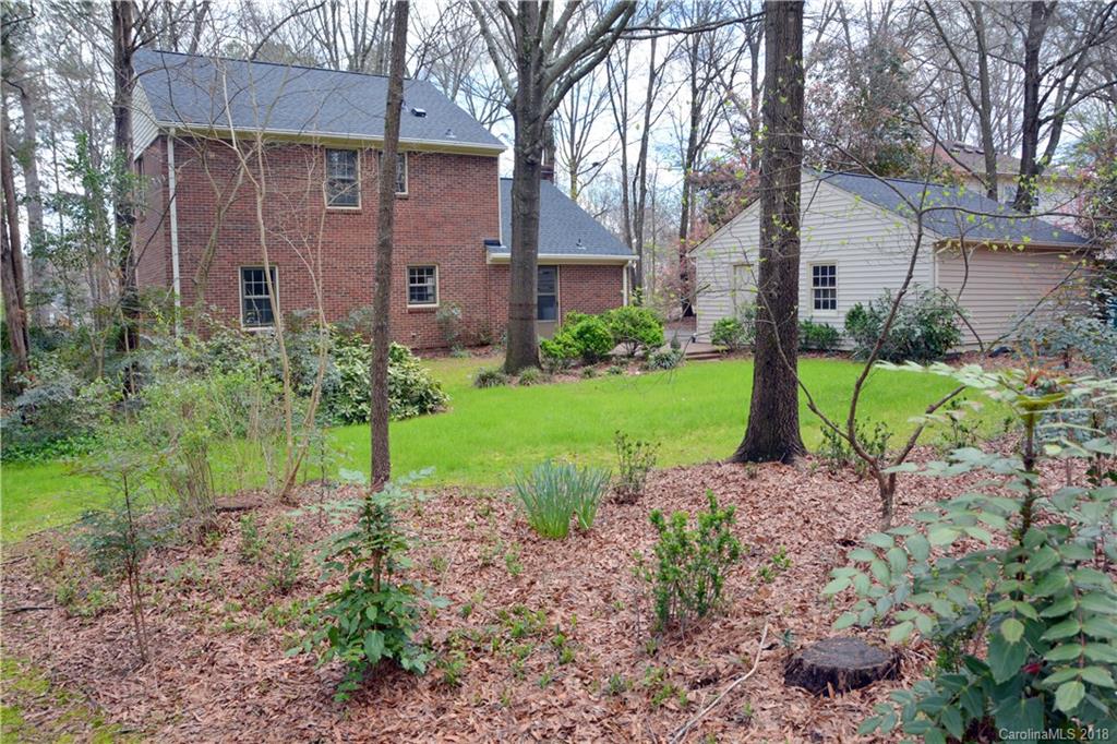 8700 Houston Ridge Road Charlotte, NC 28277 - Photo 21 of 22 a view of a brick house with a yard and large tree