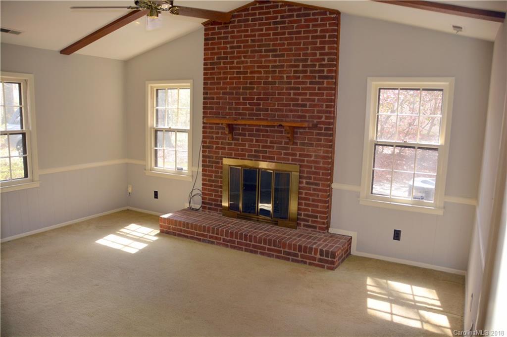 8700 Houston Ridge Road Charlotte, NC 28277 - Photo 4 of 22 an empty room with windows and fireplace
