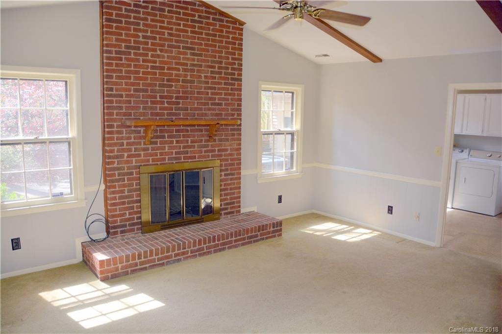 8700 Houston Ridge Road Charlotte, NC 28277 - Photo 5 of 22 a living room with a bed and a fireplace
