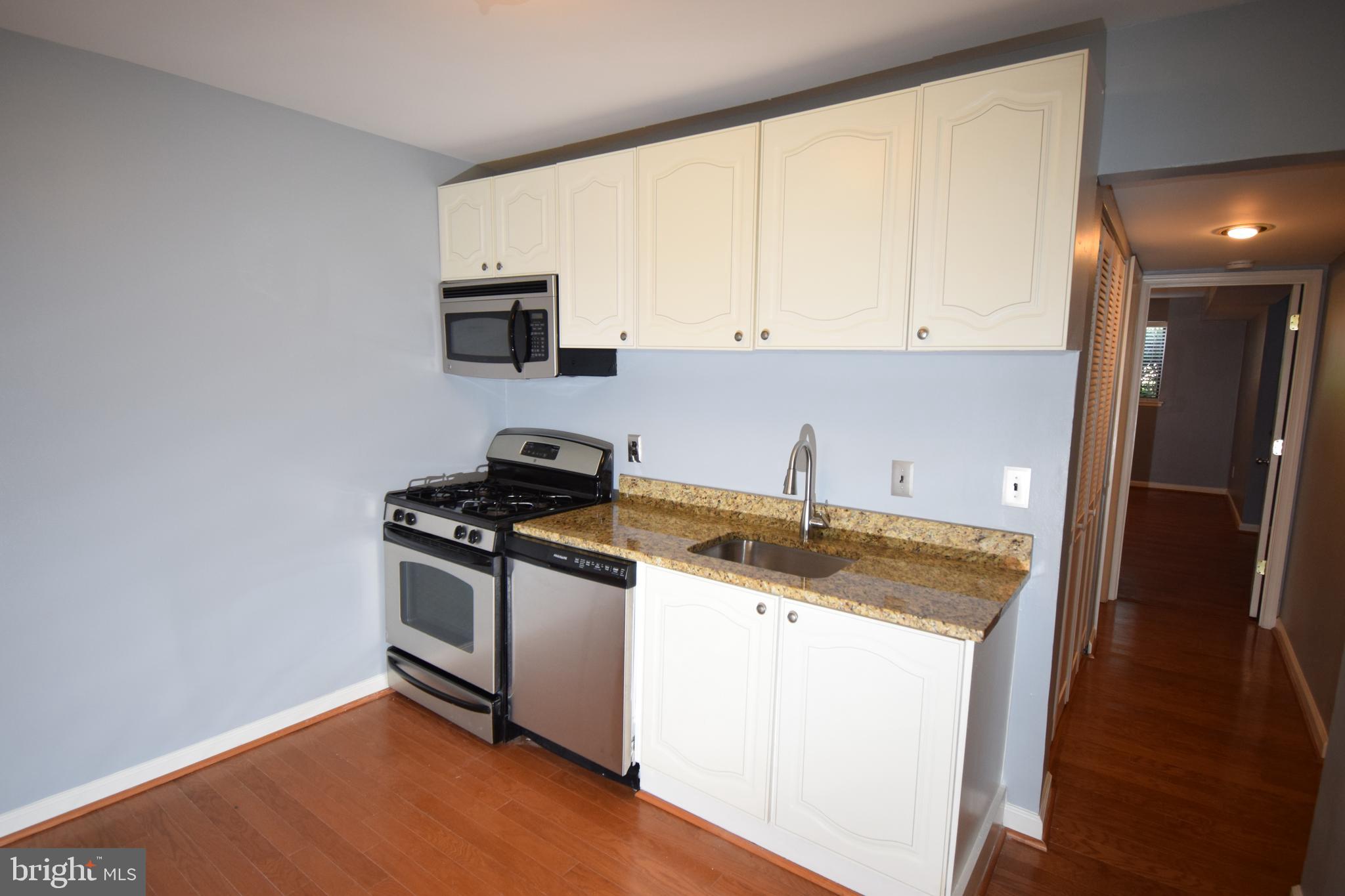 1641 Parkcrest Circle, Unit 101 Reston, VA 20190 - Photo 8 of 37 Kitchen and hall to bath and bedroom