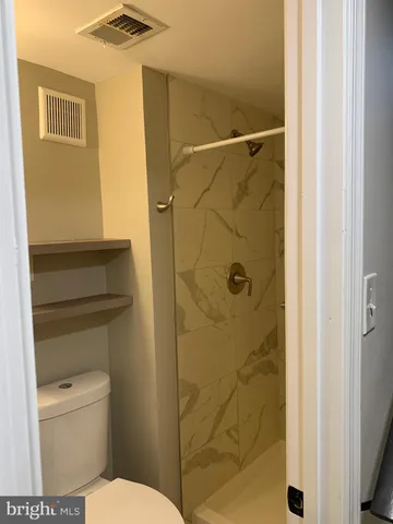 a bathroom with a toilet and shower