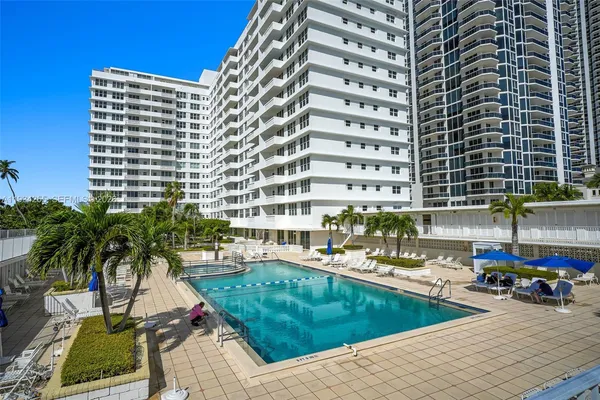 a view of a swimming pool with outdoor seating