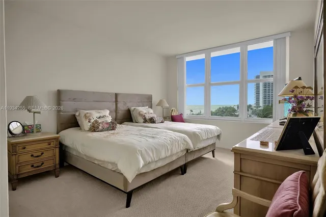 a bedroom with a bed and a large window