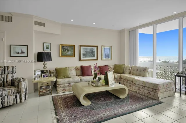 a living room with furniture and large windows