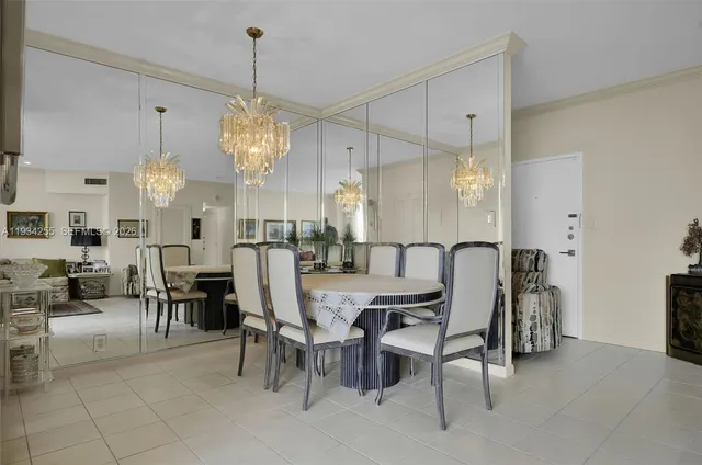 a view of a dining room with furniture and chandelier