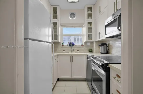 a kitchen with appliances cabinets and a sink