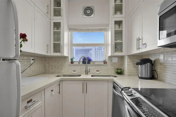 a kitchen with a sink stove and cabinets