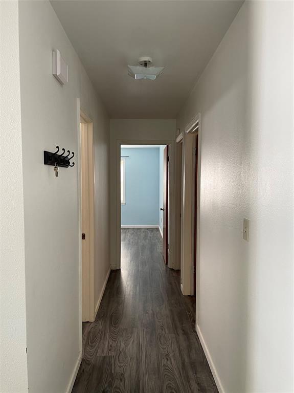 2506 Vincent Street Brownwood, TX 76801 - Photo 15 of 40 a view of a hallway with wooden floor