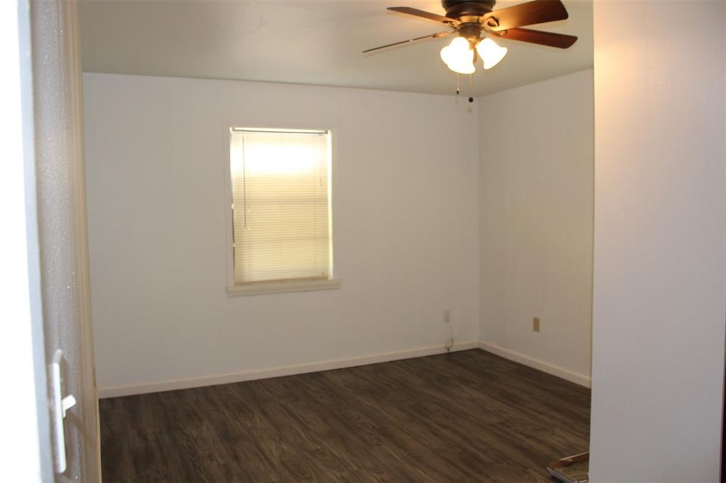 2506 Vincent Street Brownwood, TX 76801 - Photo 19 of 40 an empty room with wooden floor and windows
