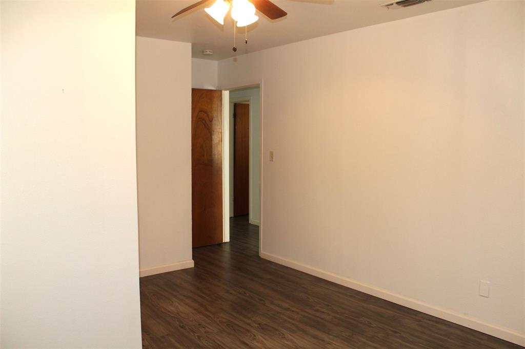 2506 Vincent Street Brownwood, TX 76801 - Photo 20 of 40 a view of an empty room with wooden floor