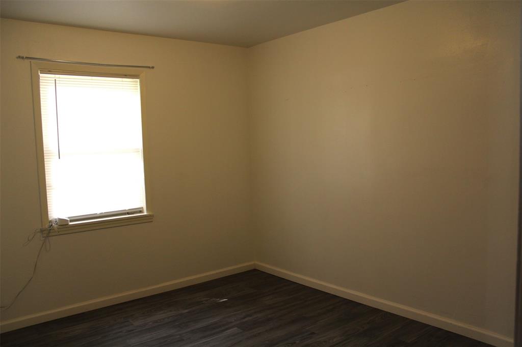 2506 Vincent Street Brownwood, TX 76801 - Photo 24 of 40 a view of a small space with wooden floor and a window