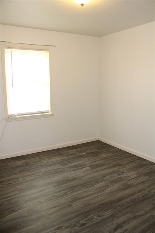 2506 Vincent Street Brownwood, TX 76801 - Photo 25 of 40 a view of an empty room with wooden floor and a window