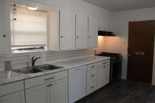 a kitchen with a sink and cabinets
