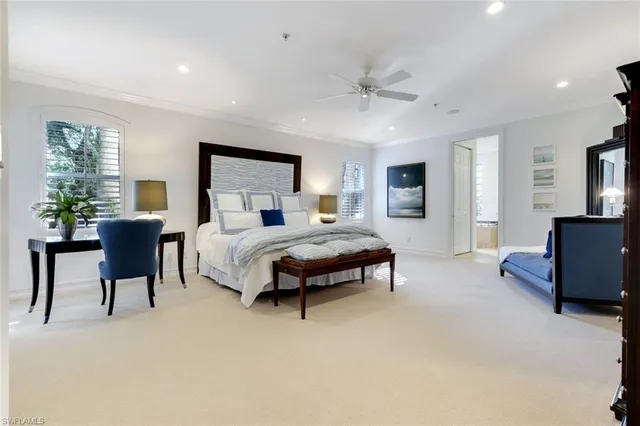 a bedroom with a bed large window and a couch