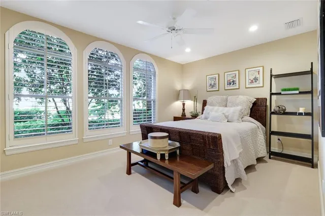 a bedroom with furniture and a large window