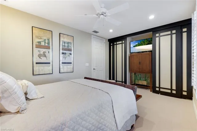 a bedroom with a large bed and a large window