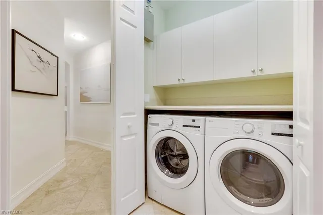 a view of a hallway with washer and dryer