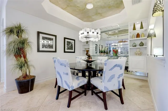 a view of a dining room with furniture and a potted plant